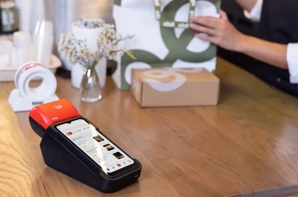 Rented handheld POS device on a coffee shop counter